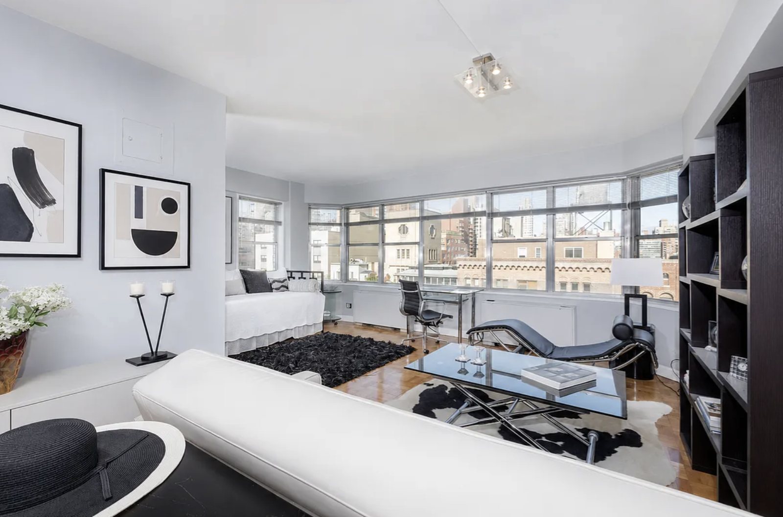 Bright Upper East Side apartment living room with corner windows, parquet floors and city views